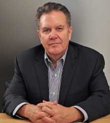 A man in a suit sitting at a table