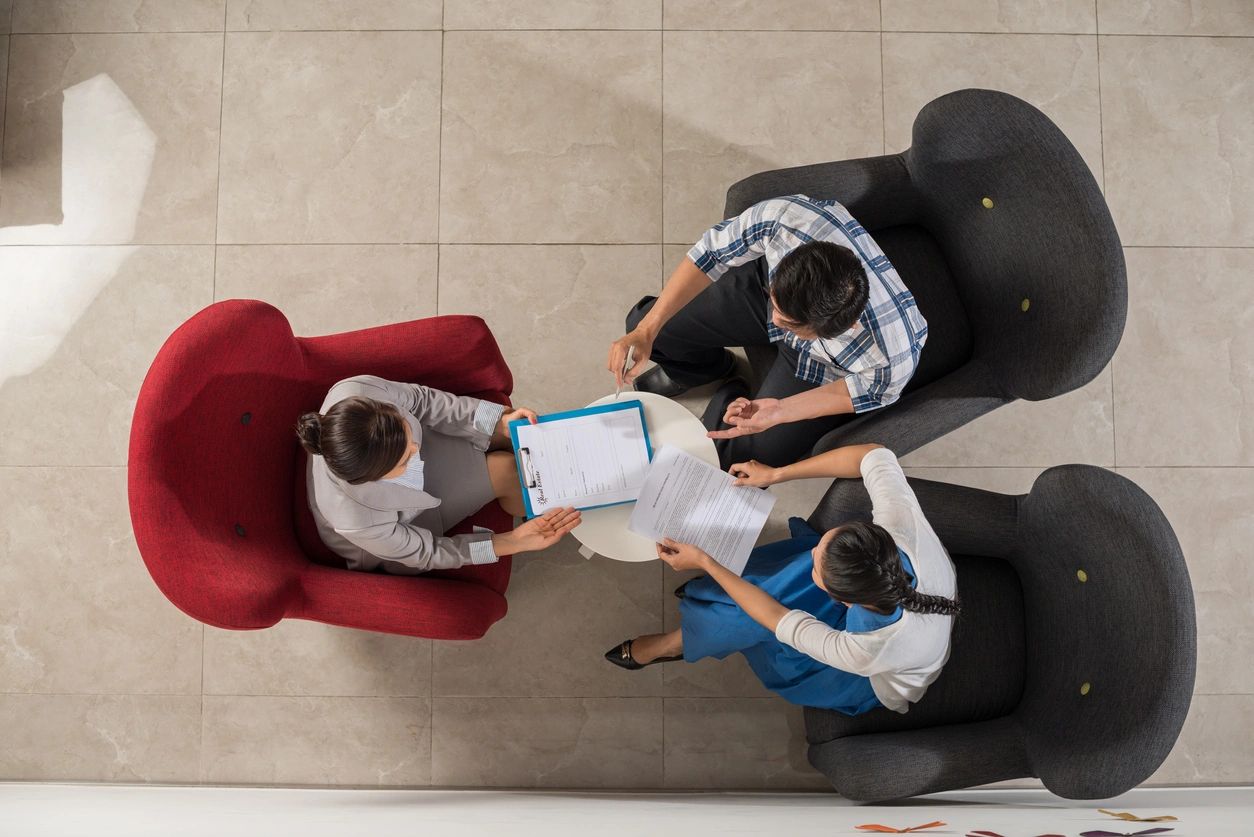 A group of people sitting around each other.